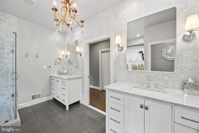 bathroom featuring a stall shower, visible vents, and a sink