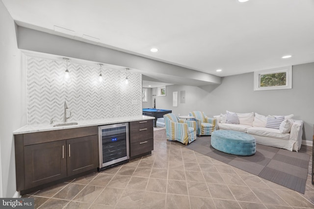 bar with backsplash, beverage cooler, recessed lighting, wet bar, and a sink