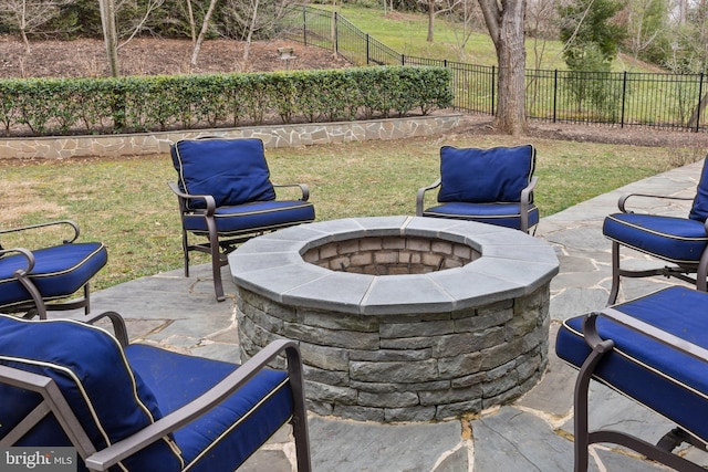 view of patio featuring an outdoor fire pit and fence