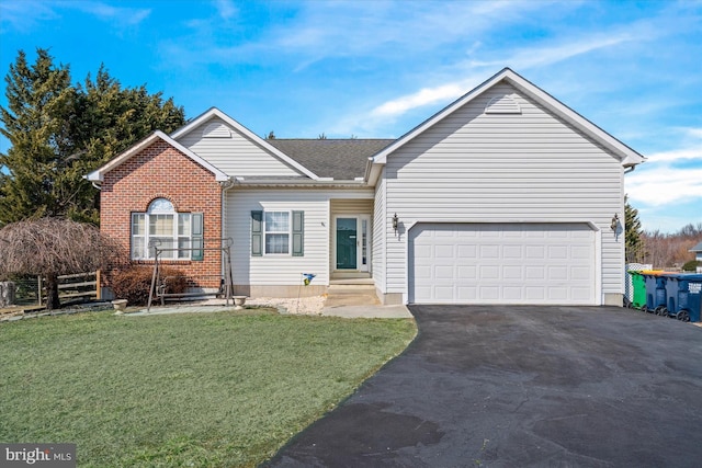 ranch-style house featuring aphalt driveway, an attached garage, fence, a front yard, and brick siding