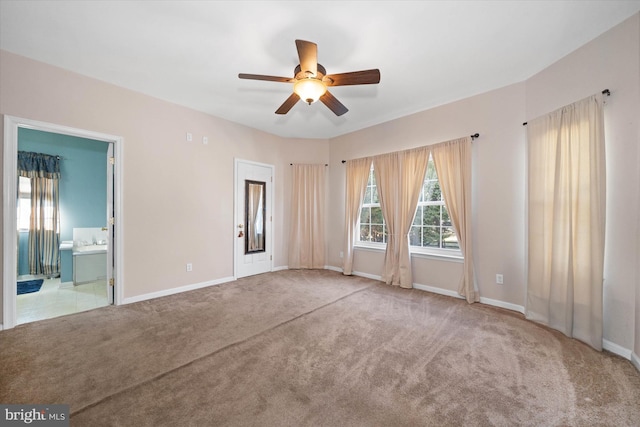 empty room with carpet floors, ceiling fan, and baseboards