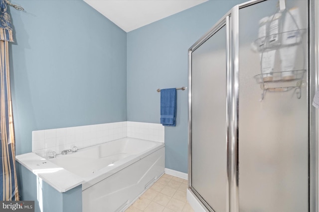 full bath featuring baseboards, a stall shower, a bath, and tile patterned floors