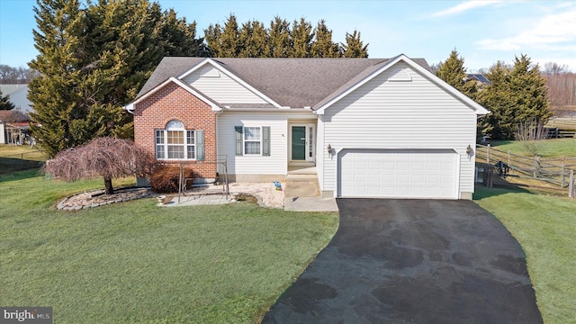 ranch-style home with fence, a front lawn, aphalt driveway, and brick siding