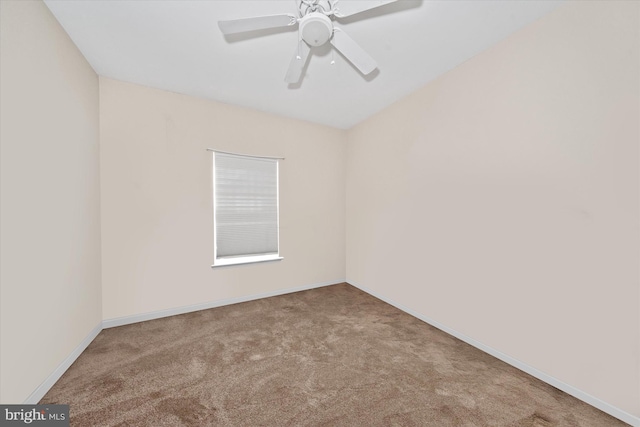 unfurnished room with a ceiling fan, carpet, and baseboards