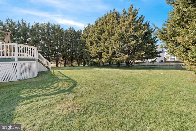 view of yard with a deck and fence