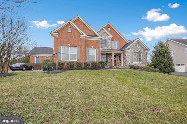 traditional-style home featuring a front lawn, brick siding, and stone siding