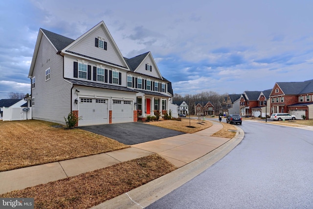 view of front of house with a garage, a residential view, aphalt driveway, metal roof, and a standing seam roof