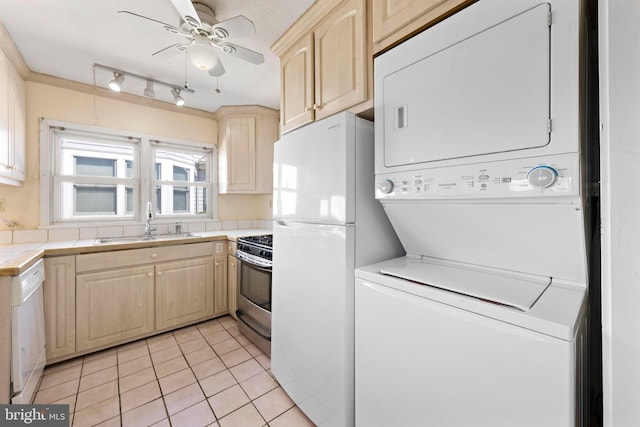 kitchen featuring tile counters, light brown cabinetry, stacked washer and clothes dryer, white appliances, and a sink