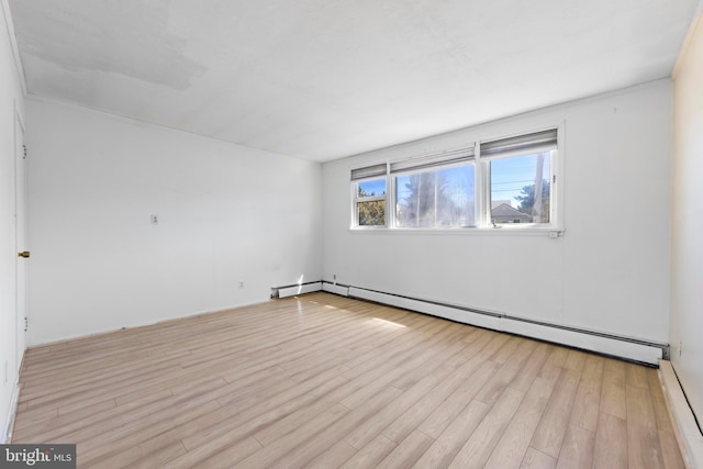 unfurnished room with light wood-type flooring and a baseboard radiator