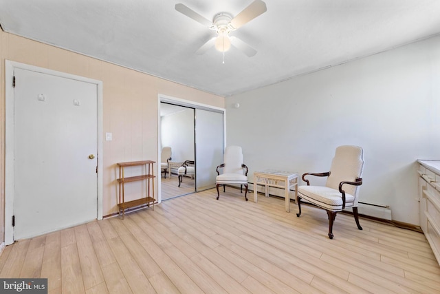 living area with a ceiling fan and light wood-style floors