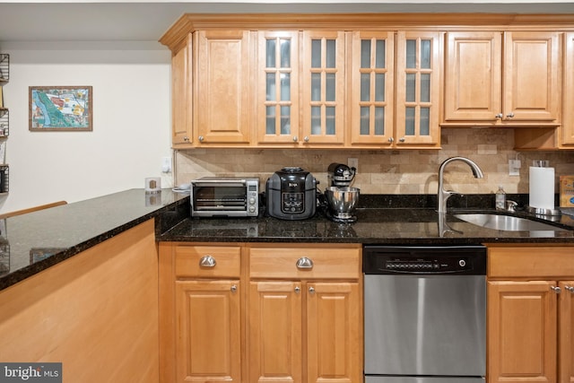 kitchen with a sink, tasteful backsplash, stainless steel dishwasher, and a toaster