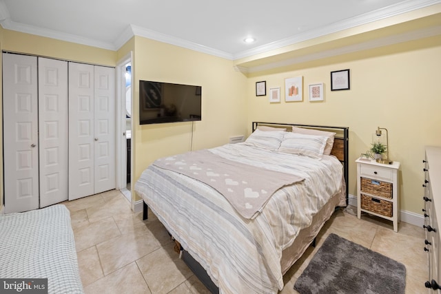 tiled bedroom featuring a closet, crown molding, and baseboards