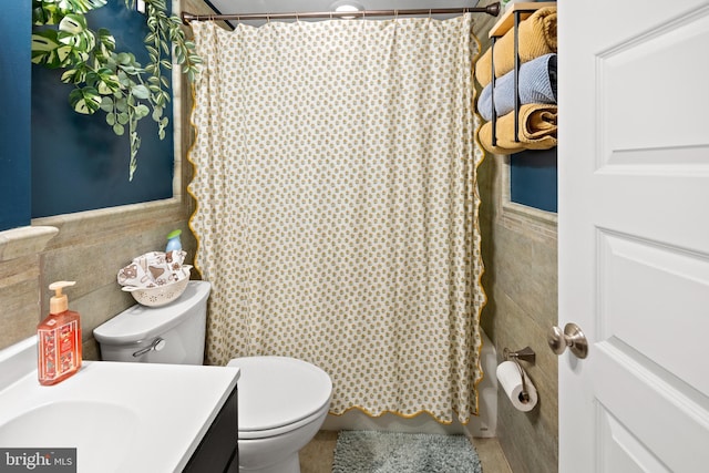 full bath with vanity, tile walls, shower / tub combo, and toilet