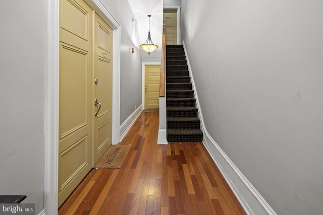 interior space featuring stairway, baseboards, and wood-type flooring