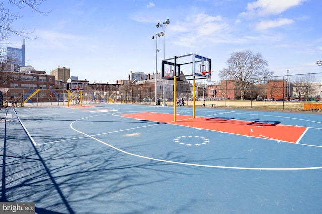 view of basketball court featuring community basketball court and fence