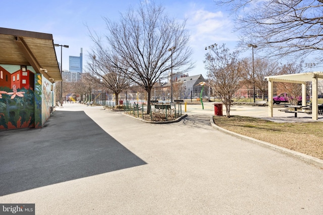 view of street featuring street lights and curbs