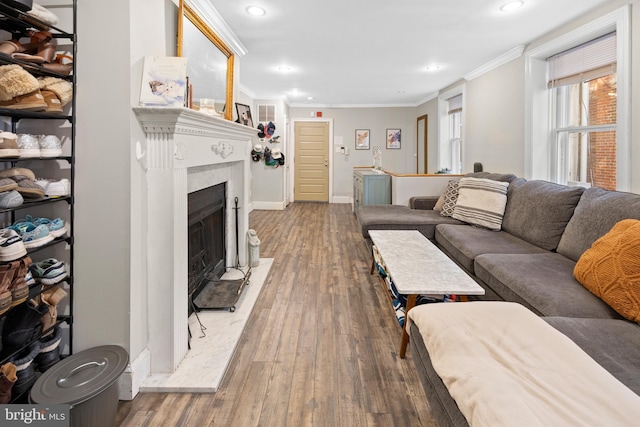 living room with ornamental molding, wood finished floors, recessed lighting, a fireplace, and baseboards