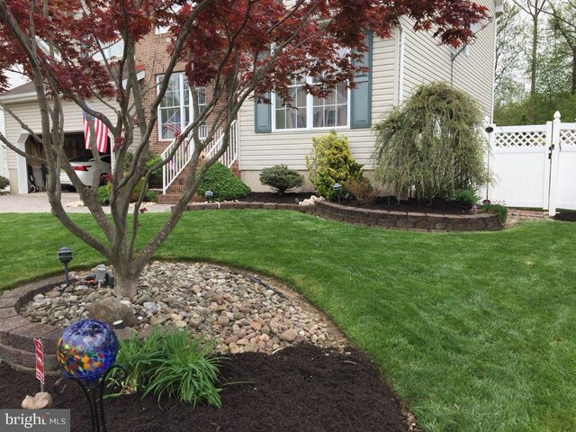 exterior space featuring a front yard and fence