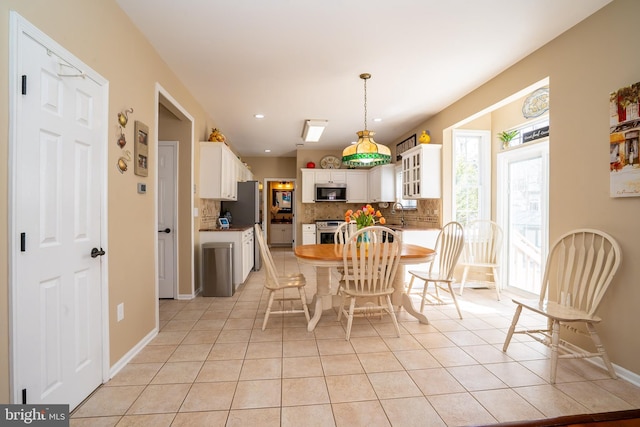 dining area featuring light tile patterned floors, recessed lighting, and baseboards