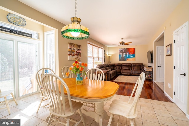 tiled dining area with a ceiling fan