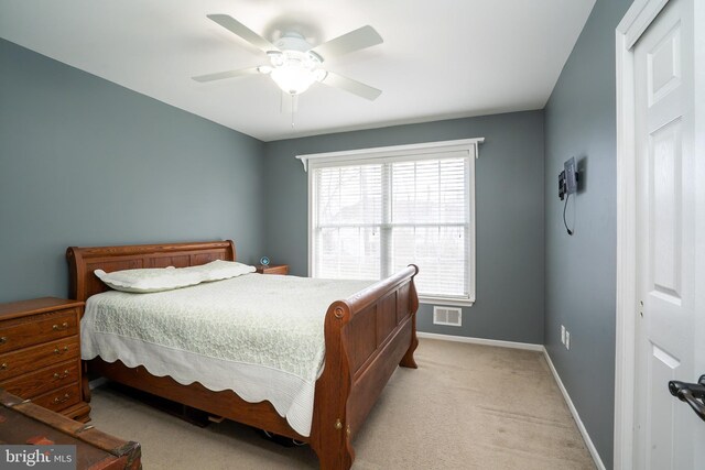 bedroom with light carpet, visible vents, ceiling fan, and baseboards