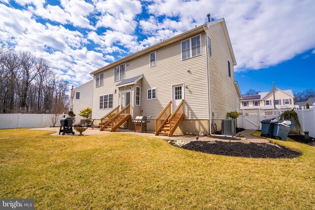 back of property with central AC unit, a yard, a fenced backyard, entry steps, and a patio area