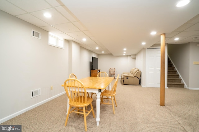 carpeted dining space with recessed lighting, visible vents, baseboards, and stairway