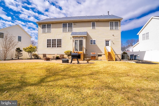 back of house featuring entry steps, a yard, a patio area, and fence