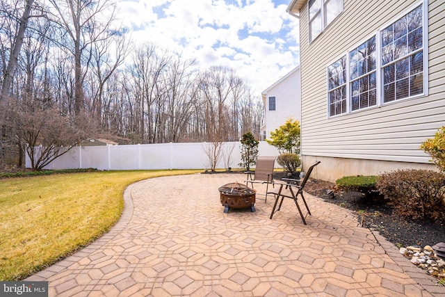 view of patio / terrace with an outdoor fire pit and fence