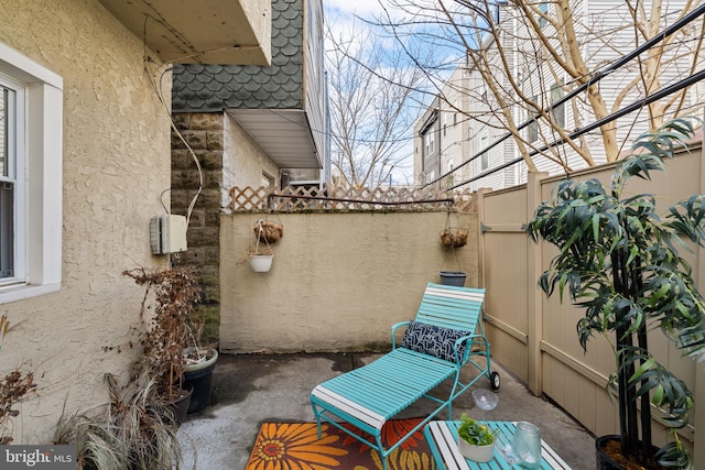 view of patio / terrace featuring fence