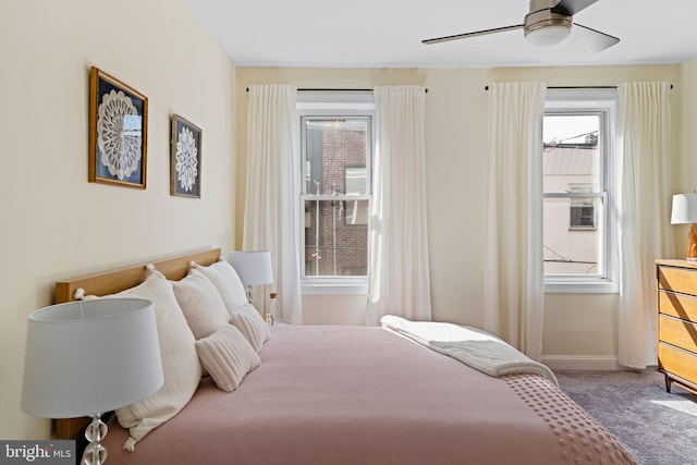 bedroom with carpet, multiple windows, ceiling fan, and baseboards