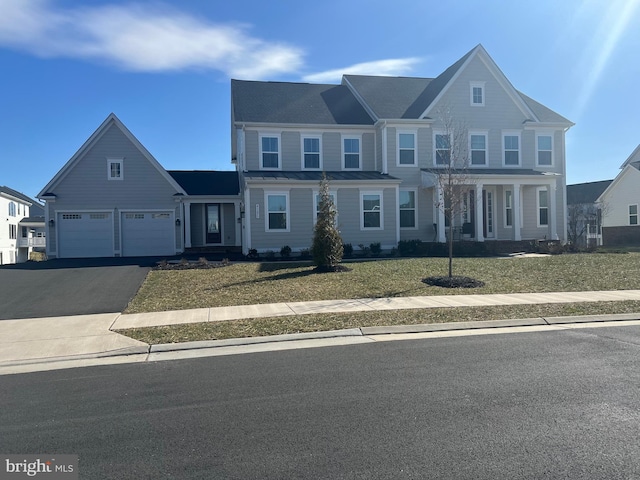 view of front of home with driveway, a standing seam roof, a front lawn, a garage, and metal roof