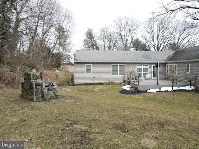 rear view of property with a yard