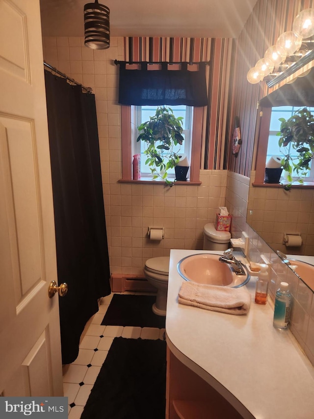 full bathroom with tile walls, vanity, toilet, and wallpapered walls