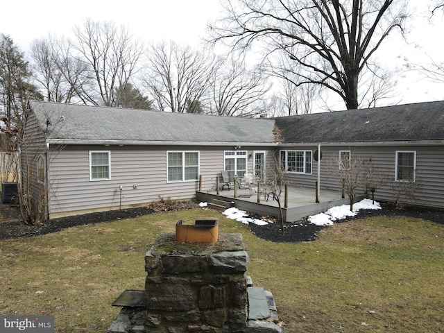 rear view of property with roof with shingles, a yard, a deck, and central air condition unit