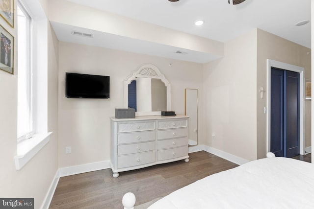 bedroom featuring recessed lighting, wood finished floors, visible vents, and baseboards