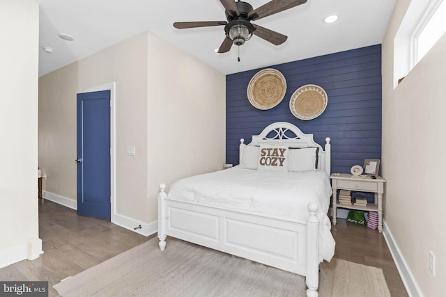 bedroom with a ceiling fan, recessed lighting, baseboards, and wood finished floors