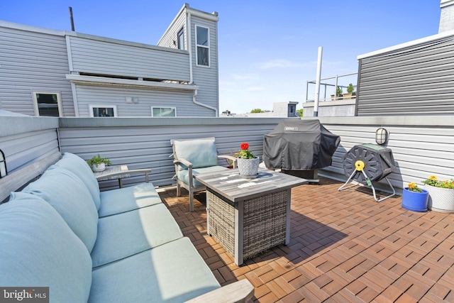 wooden deck featuring a patio area, outdoor lounge area, and grilling area