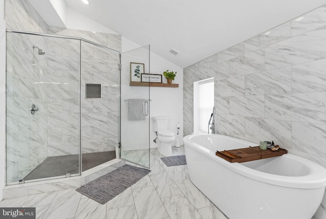 bathroom with lofted ceiling, toilet, a soaking tub, marble finish floor, and a shower stall