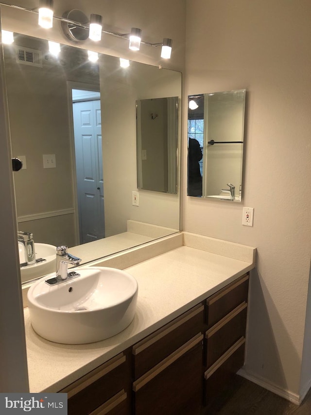 bathroom with vanity and visible vents