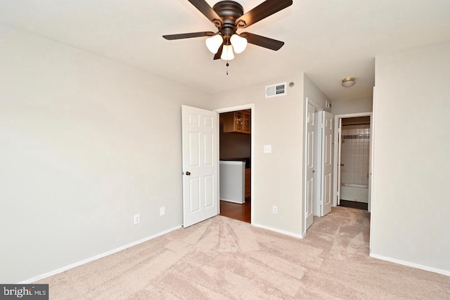 unfurnished bedroom featuring baseboards, visible vents, and carpet floors