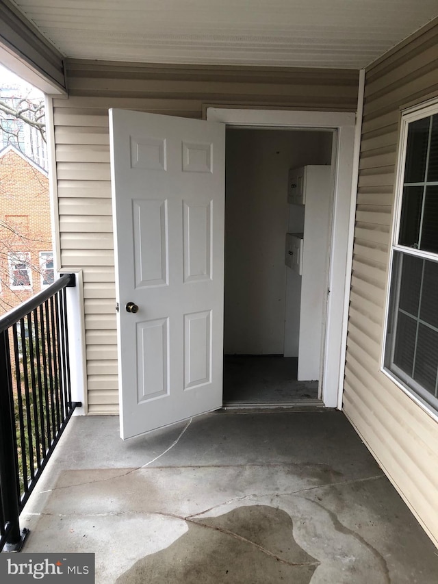 view of exterior entry with a balcony