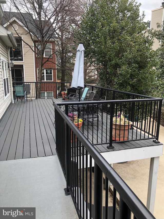 wooden terrace featuring outdoor dining space