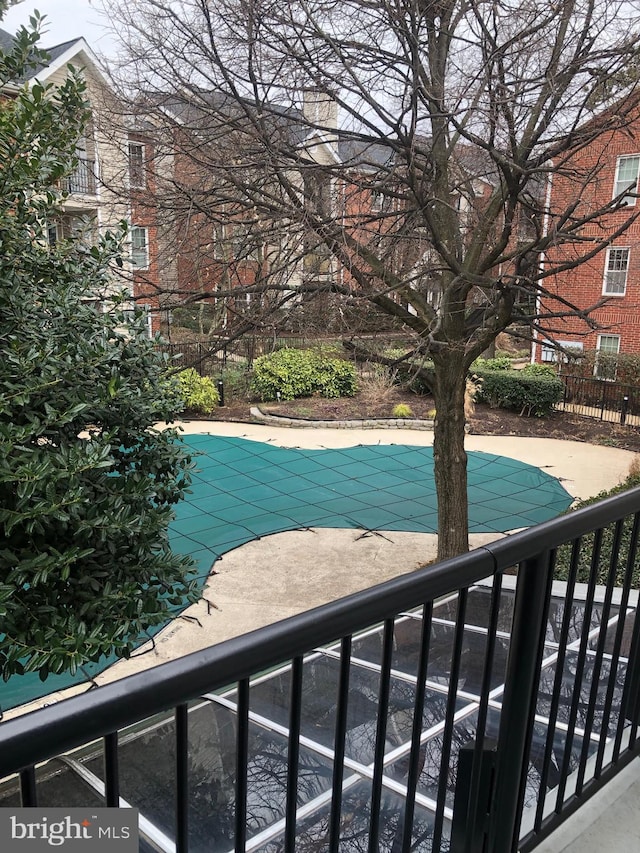 view of swimming pool with a patio area, a fenced in pool, and fence