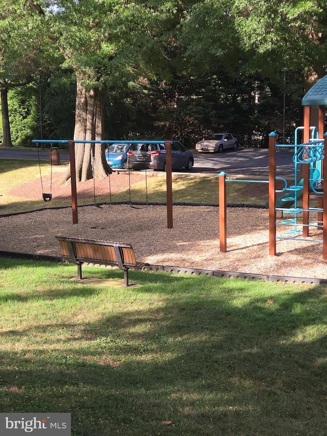 communal playground featuring a lawn