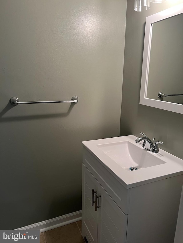 bathroom with vanity, baseboards, and tile patterned floors