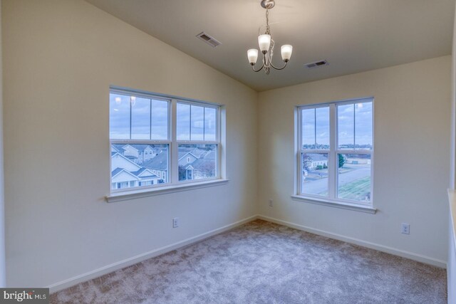 4902 E Pebble Ln Unit E, Milford, DE 19963 - carpeted empty room featuring a chandelier, visible vents, baseboards, and vaulted ceiling