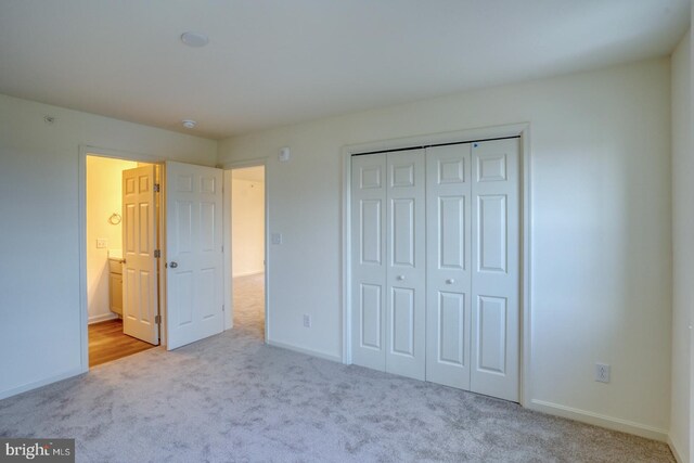 4902 E Pebble Ln Unit E, Milford, DE 19963 - unfurnished bedroom with a closet, carpet flooring, and baseboards