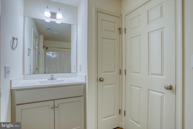 4902 E Pebble Ln Unit E, Milford, DE 19963 - full bathroom featuring vanity, visible vents, and walk in shower