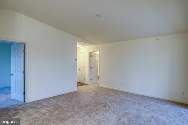 4902 E Pebble Ln Unit E, Milford, DE 19963 - spare room with baseboards, lofted ceiling, and carpet floors